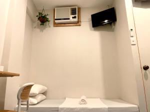 a room with a table and a microwave on the wall at Chill Out Hostel in Boracay