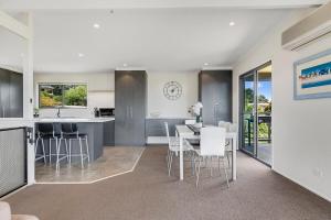 a kitchen and dining room with a table and chairs at The Beach House - Views & Games Room in Mount Martha