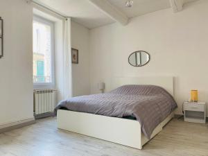 レ・ペンヌ・ミラボーにあるTriplex cosy au cœur du villageのベッドと鏡のある白い寝室