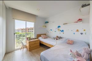 a bedroom with two beds and a window at Ático sagaro in Sant Feliu de Guixols +4 photos