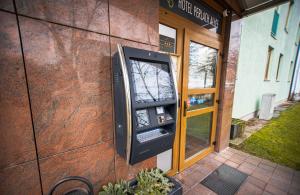 an atm machine on the side of a building at Hotel Perlach Allee by Blattl in Munich