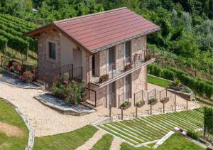 a small brick house with a metal roof at I Quattro Pozzi in La Morra