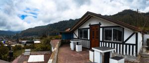a small house with a view of a mountain at The paulwood cabana and Bungalow in Nuwara Eliya