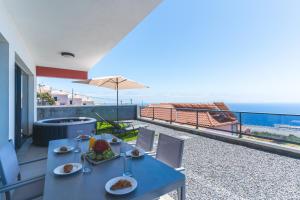 a blue table with food on it on a balcony at Blue Outlook View by Atlantic Holiday in Água de Pena