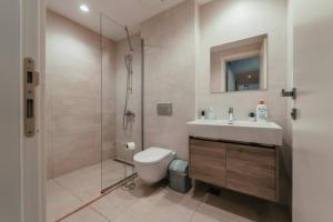 a bathroom with a toilet and a sink and a shower at BW Cityline Residences in Belgrade +38 photos