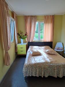 a bedroom with a large bed and a window at Dvēseles veldzes dārzs in Ziemupe +63 photos