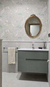 a bathroom with a sink and a mirror at Maruja Rural 2 in Sober