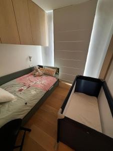 a bedroom with a bed with a teddy bear on it at Appartement Knokke - 2 Chambres in Knokke-Heist