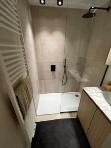 a bathroom with a shower and a sink at Appartement Knokke - 2 Chambres in Knokke-Heist