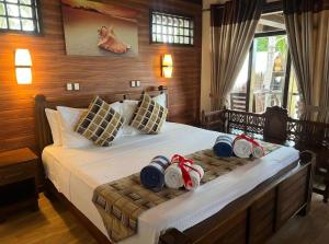 a bedroom with a bed with hats and towels on it at Nilaveli Beach Resort - Level 1 Certified in Nilaveli
