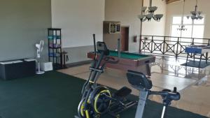a gym with a bicycle and a pool table at Villa Fleur De Lys in Makunduchi
