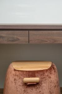 a wooden counter top with a stool under a drawer at Schäfle Feldkirch-Altenstadt in Feldkirch