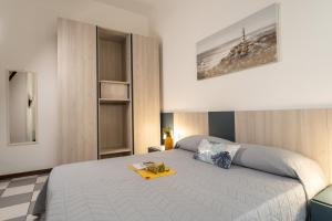 Postel nebo postele na pokoji v ubytování Appartamenti Casa De Lazzari - Piazza Brescia - Adria Holiday Jesolo - FAMILY APARTMENTS + 60 fotografií