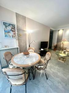 a dining room with a table and chairs at Le Cyrille in Antibes