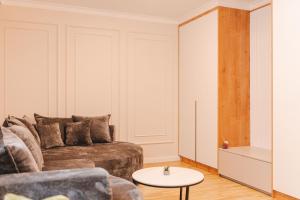 a living room with a couch and a table at Stylish Stay - Workspace & Netflix Included in Cluj-Napoca +17 photos