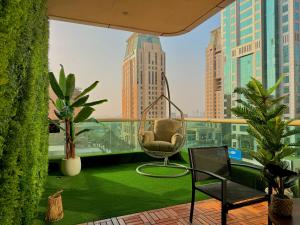 a room with a chair on a balcony at Stylish Studio Apartment with large Balcony and Sea Views, free Parking, Dubai Marina - JBR in Dubai