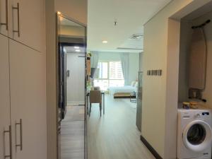 a bathroom with a washer and dryer in a room at Stylish Studio Apartment with large Balcony and Sea Views, free Parking, Dubai Marina - JBR in Dubai