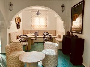 a restaurant with chairs and tables in a room at Riad Dar Elif in Tangier