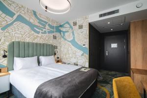 a hotel room with a bed and a wall mural at Focus Hotel Premium Wrocław in Wrocław +116 photos