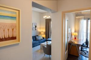 a living room with a blue couch and a table at City Nook - Apt in Heraklion Centre in Bendevís