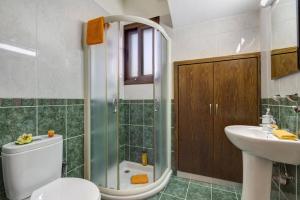 a bathroom with a shower and a toilet and a sink at Villa Kassiopeia by Villa Plus in Peyia +44 photos