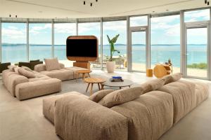 a living room with a large couch and a tv at Radisson Blu Resort & Spa in Split +37 photos