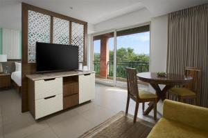 a living room with a television and a dining table at Mandrem Beach Resort, a member of Radisson Individuals Retreat in Mandrem +159 photos