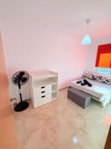 a bedroom with a bed and a dresser and a lamp at Villa del sol in Creixell