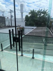 a view of a tennis court through a glass window at Apto Lindo e Aconchegante 3 in Manaus
