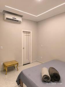 a bedroom with a bed and a air conditioner at Apto Lindo e Aconchegante 3 in Manaus