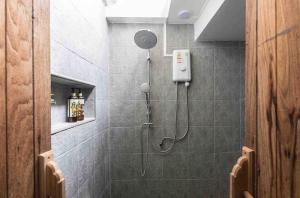 a shower with a shower head in a bathroom at Baan Ploen Dee - Wat Arun in Bangkok +29 photos