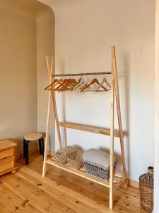 a wooden shelf with shoes on it in a room at KULDIGA CENTRE wooden apartment in Kuldīga