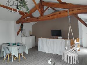 a room with a table and chairs and a tv at La Cabane aux Hirondelles in Entraigues +17 photos