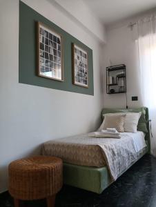 a bedroom with a bed and two pictures on the wall at HOST HOUSE in Bordighera +14 photos