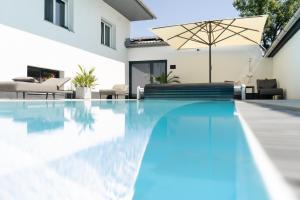 an image of a swimming pool in a house at KRACHER Familienapartment mit Nationalparkblick in Illmitz
