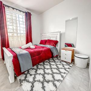 a bedroom with a red bed and a mirror at Anada Estate, Gikambura, Thogoto, Kikuyu, Kiambu County in Nairobi