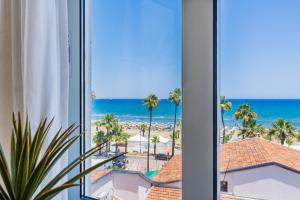 una habitación de hotel con vistas a la playa en Whispering Palms 1-BR Apt By Finikoudes Beach, en Lárnaca