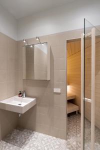 a bathroom with a sink and a shower at Vallikraavi apartment with sauna in Tartu
