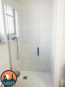 a bathroom with a shower with a glass door at Cala Nuevo Montijo by Bossh! Apartments in Chipiona