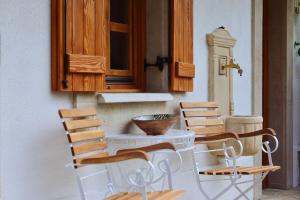 a group of chairs sitting next to a table at Anna Vendégház Kesztölc in Kesztölc +35 photos