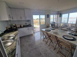 a kitchen with a table and chairs in a room at Villa Brisamar - On the beach in Peniscola