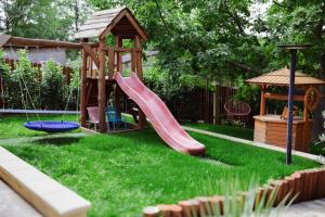 a playground with a slide and a gazebo at Anna Vendégház Kesztölc in Kesztölc