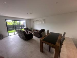 a living room with a table and chairs at Spacious Queen Room with Attached Bathroom - OR1 in Guildford