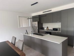 a kitchen with a counter and a sink and a stove at Spacious Queen Room with Attached Bathroom - OR1 in Guildford