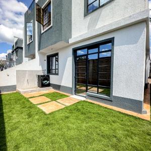 a house with a green lawn in front of it at Anada Estate, Gikambura, Thogoto, Kikuyu, Kiambu County in Nairobi