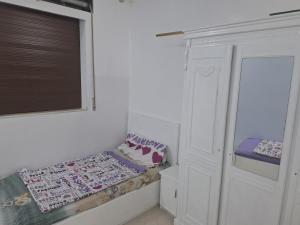 a small room with a bed and a window at منزل للكراء اليومي in Chefchaouen