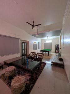 a living room with a table and a pool table at Sanctuary by Nagarik Commune in Pune
