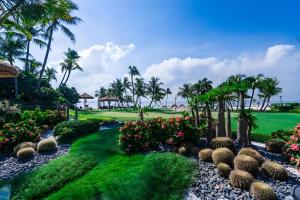 a view of a golf course with palm trees and plants at Forest City Golf Villa by Avery at Johor #Home Party#Located in Golf Resort#Free Parking#中英文房东 in Johor Bahru