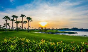 a view of a golf course with palm trees and a lake at Forest City Golf Villa by Avery at Johor #Home Party#Located in Golf Resort#Free Parking#中英文房东 in Johor Bahru