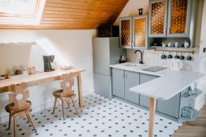 a kitchen with a table and two chairs in it at Agroturystyka u Marleny in Skorzenno